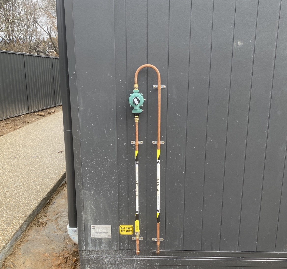 Gas fitter testing a gas line with electronic leak detector
